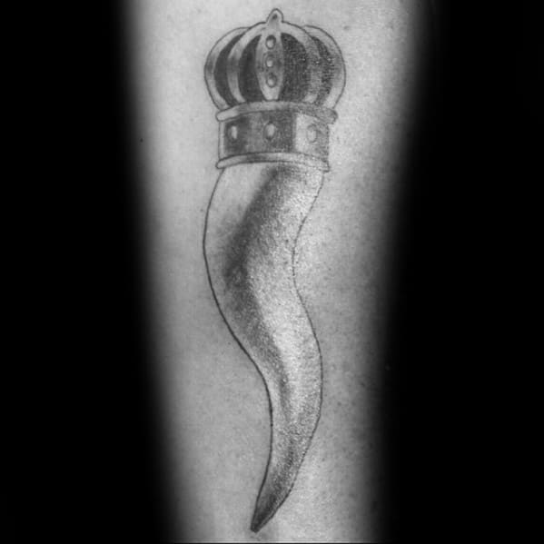 Black and grey Italian horn tattoo with a bold crown, symbolizing protection, strength, and cultural heritage.