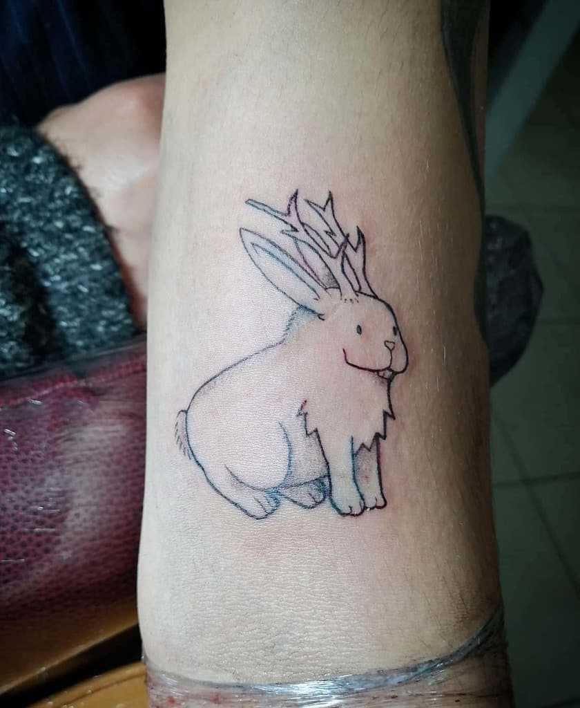 Simple line tattoo of a rabbit with delicate antlers, creating a whimsical, minimalistic design with soft colors and clean lines