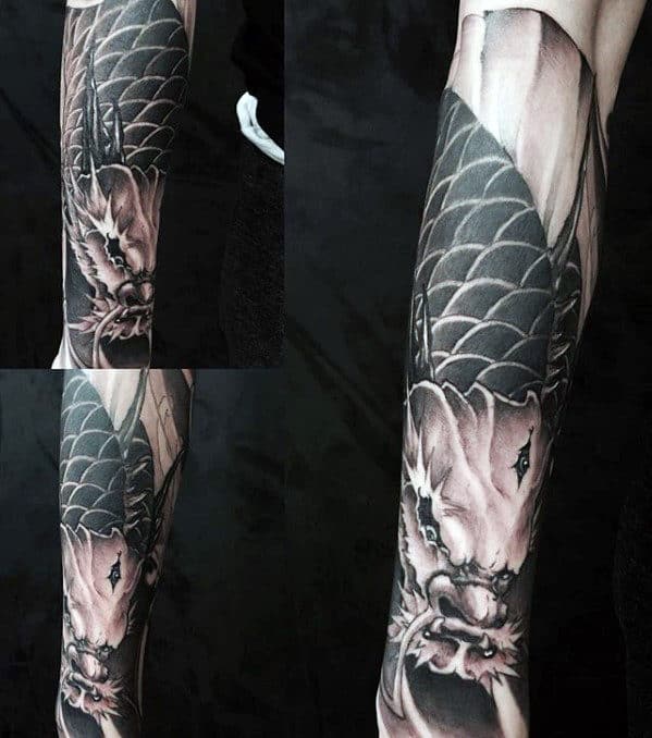 Black and grey dragon tattoo sleeve on an arm