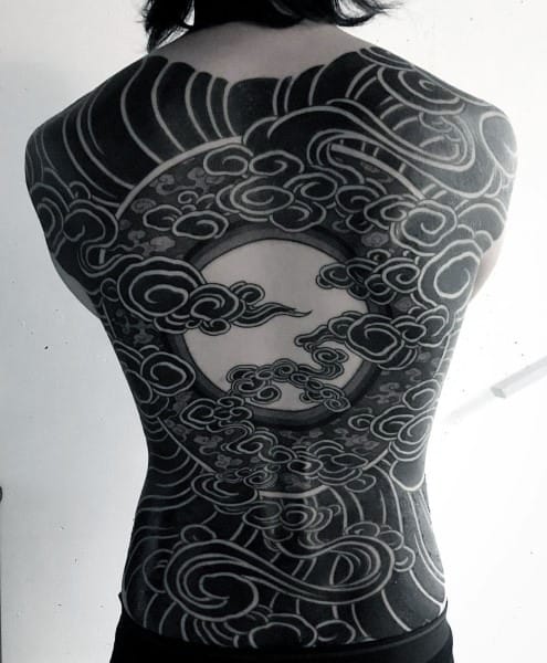 Bold full back Japanese-style tattoo of swirling clouds around a blank circular center, symbolizing balance, nature’s flow, and spiritual calm.