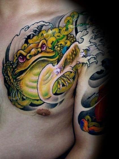 Japanese-style chest tattoo featuring a fierce golden toad with red eyes, surrounded by crashing waves and gold coins, symbolizing fortune and power.
