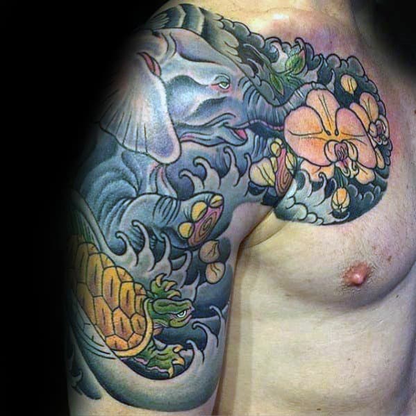 Japanese-style chest and sleeve tattoo featuring a turtle, an elephant, waves, and floral elements, creating a dynamic and symbolic design.