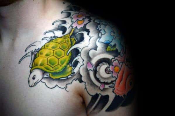 Japanese-style shoulder tattoo featuring a vibrant green turtle, flowing waves, cherry blossoms, and koi fish, symbolizing longevity and harmony.