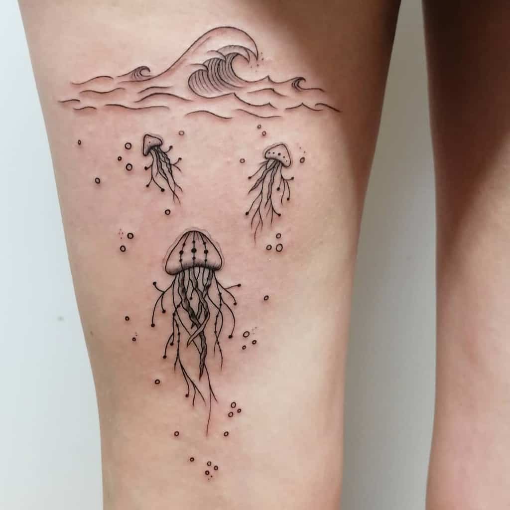 Minimalist jellyfish tattoo, featuring delicate linework with floating jellyfish, ocean waves, and bubbles