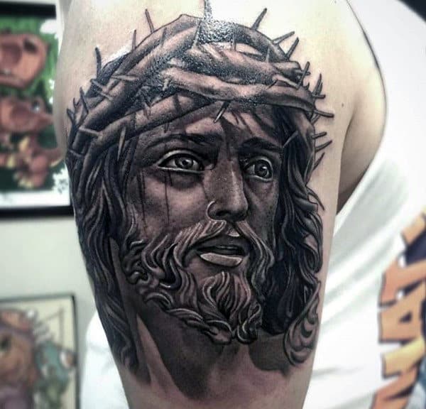 Jesus Face Male Upper Arm Tattoo With Black And Grey Ink