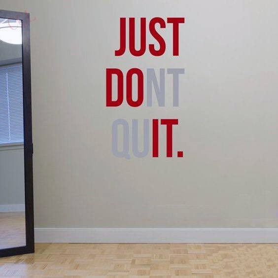 Inspiring wall art featuring the motivational phrase "Just Don't Quit" in bold red and grey typography.