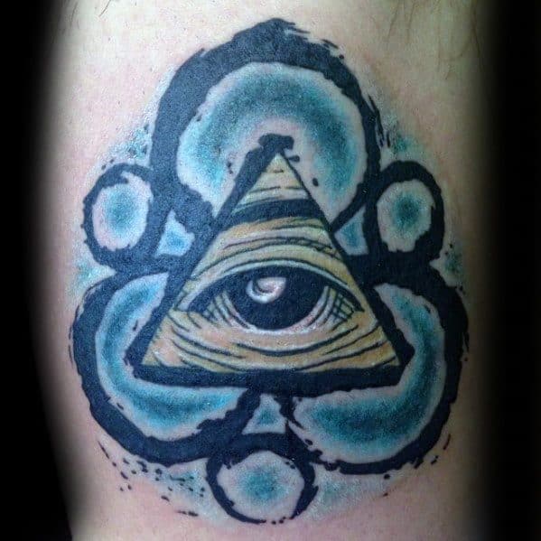 Coheed and Cambria Keywork tattoo with a central all-seeing eye inside a triangle, surrounded by teal and black brushstroke accents.