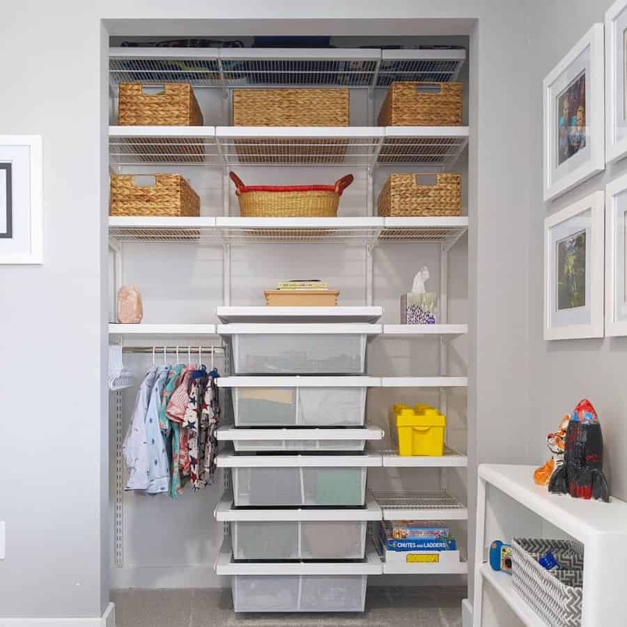 Organized bedroom reach-in closet with shelves, drawers, and woven baskets.