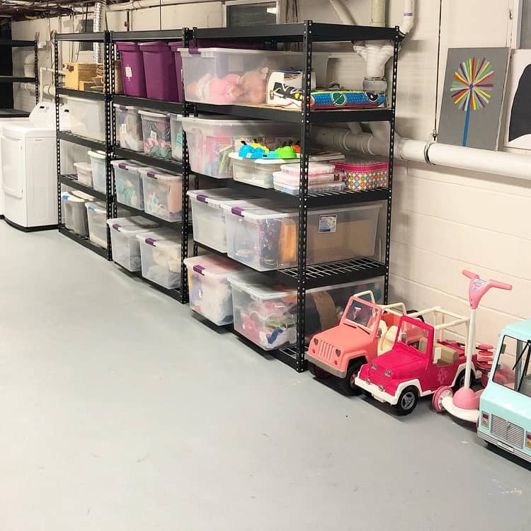 Basement shelves with labeled bins storing kids' toys and larger items for organized storage.