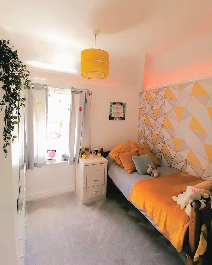 Cheerful bedroom with geometric wallpaper, vibrant yellow accents, single bed, hanging plants, and a window