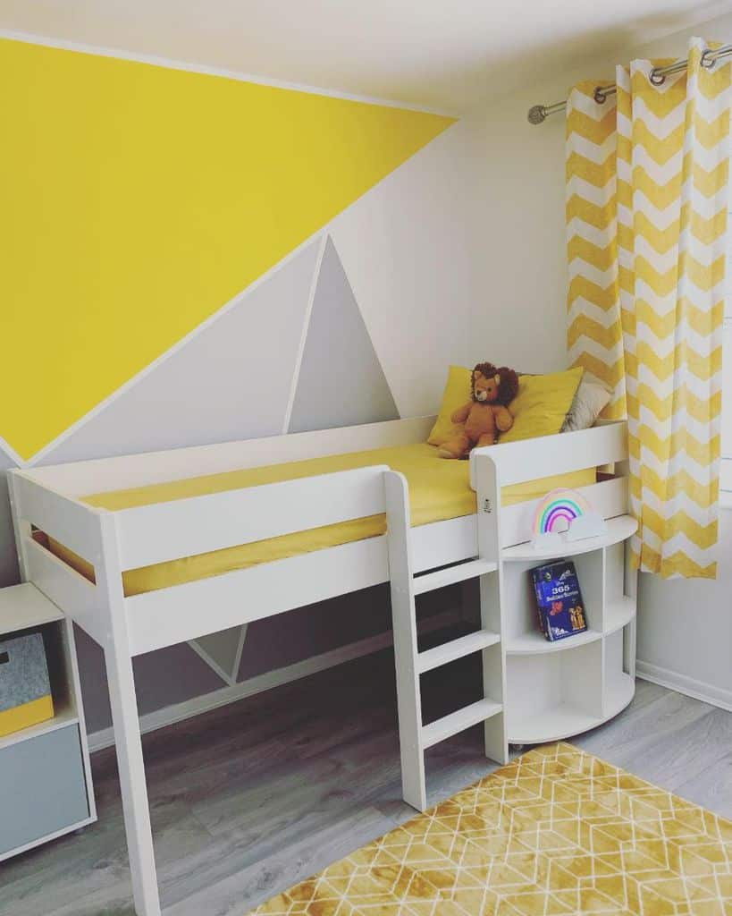 Children's room with a white loft bed, yellow geometric wall, lion plush toy, and chevron-patterned curtains
