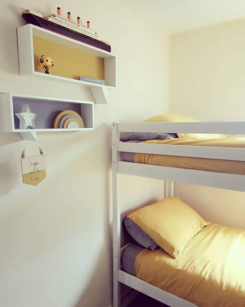 Yellow bunk bed with bedding, shelves, and decorations in a cozy room