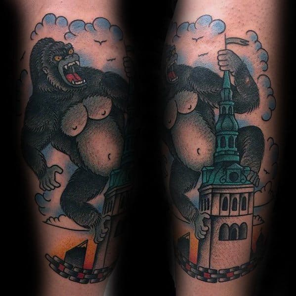 Neo-traditional King Kong tattoo with bold outlines and color, showing Kong climbing a tall tower with clouds and birds in the background.