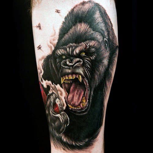 Realistic King Kong tattoo with fierce expression, showing Kong roaring while gripping a screaming woman, with planes flying overhead.