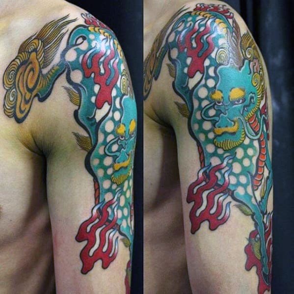 Bold upper arm Kirin tattoo with turquoise body, red flames, golden accents, and cloud motifs in a vivid traditional Japanese style.