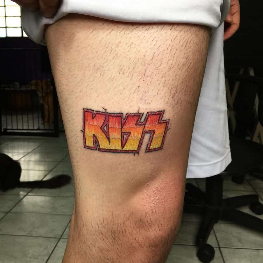 Stitch-inspired KISS logo tattoo with red and yellow tones, resembling a patch sewn onto the skin.