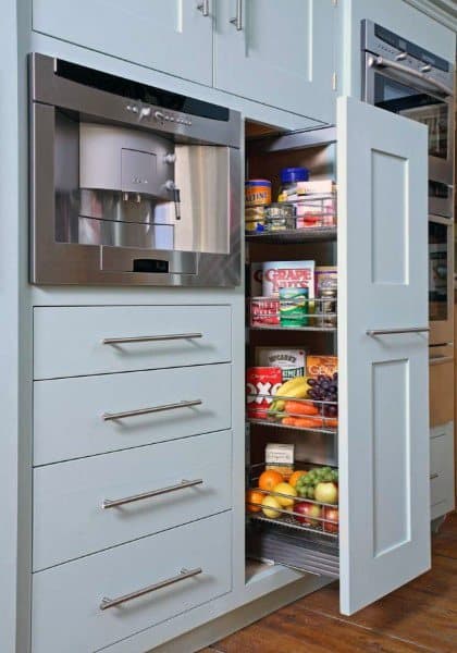 Pull-out pantry with light blue cabinetry and organized food storage.