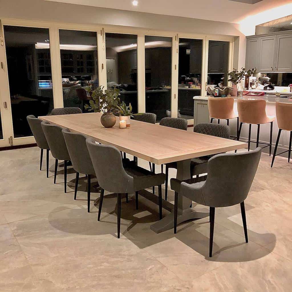 kitchen dining room long dining table with gray chairs fold out windows tile floor