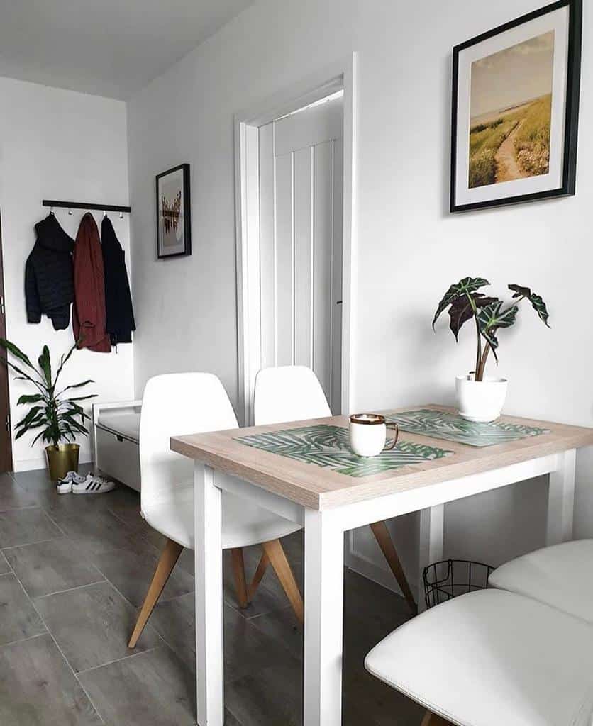 small white table and chairs pot plant wall coat hanger