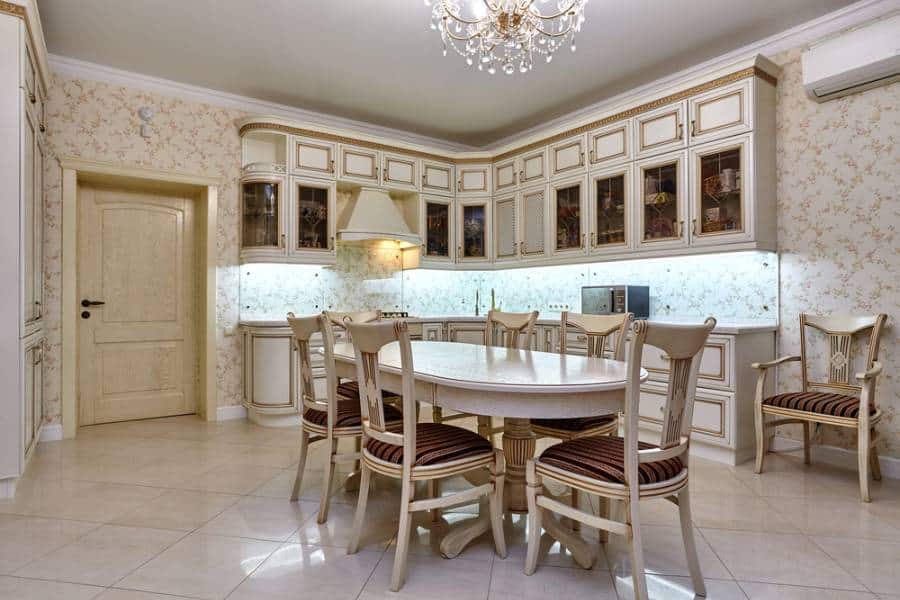 elegant kitchen tile floor round dining table chandelier white cabinets 