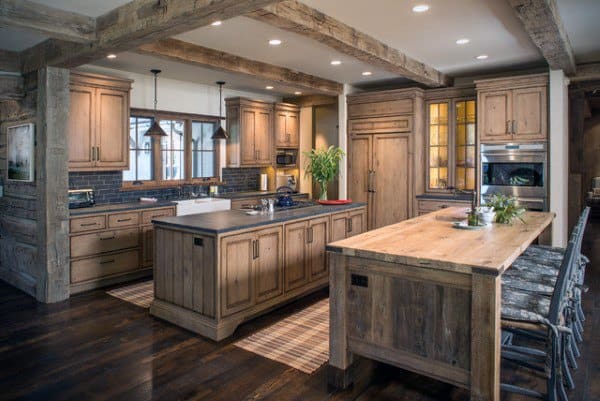 Rustic kitchen with wooden cabinets, exposed beams, farmhouse sink, and a large dining island.