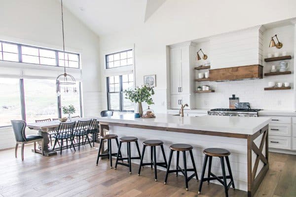 Bright rustic kitchen with a wood-framed island and farmhouse dining area.