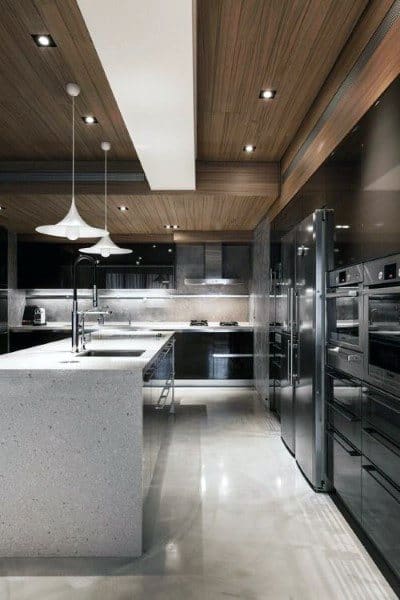 Modern kitchen featuring a spacious island, sleek black cabinets, stainless steel appliances, and wooden ceiling accents