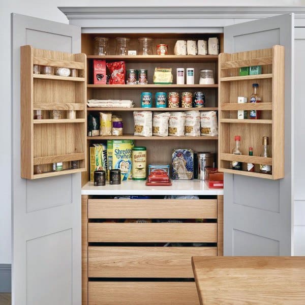 Wooden pantry with pull-out drawers, door shelves, and neatly organized groceries.