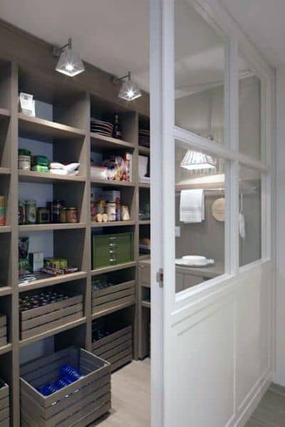 Open pantry with wooden shelving and sliding glass door for a clean, organized look.