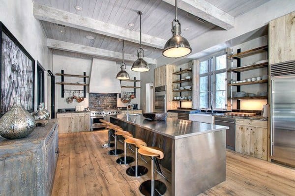 Rustic industrial kitchen with stainless steel counters, wooden cabinets, and exposed beams.