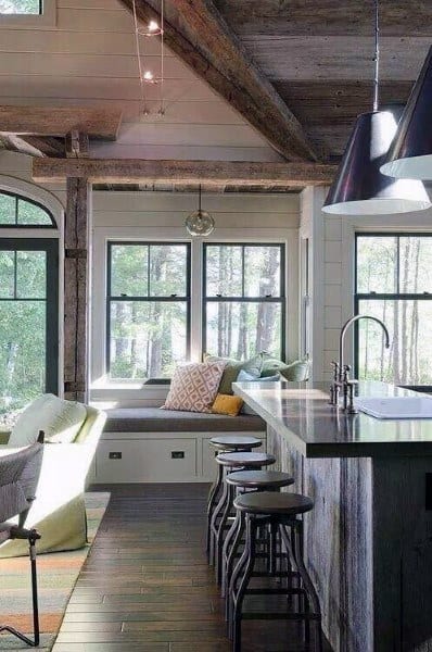 Cozy rustic kitchen with a window-side bench and reclaimed wood island.