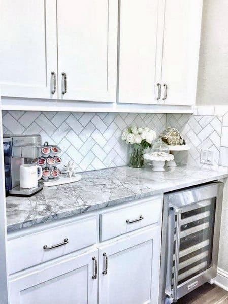 Bright kitchen nook with white herringbone stone backsplash,