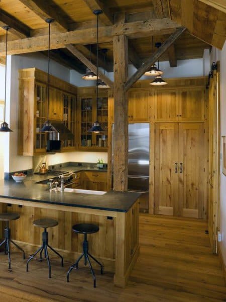 Warm rustic kitchen featuring natural wood cabinetry and exposed beams for a cozy atmosphere.