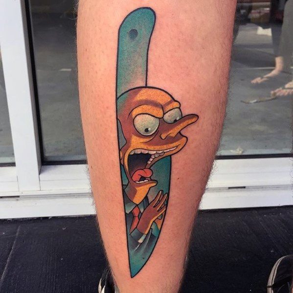 Creative tattoo of Mr. Burns from The Simpsons appearing inside a straight razor, with a shocked expression and bold colors.