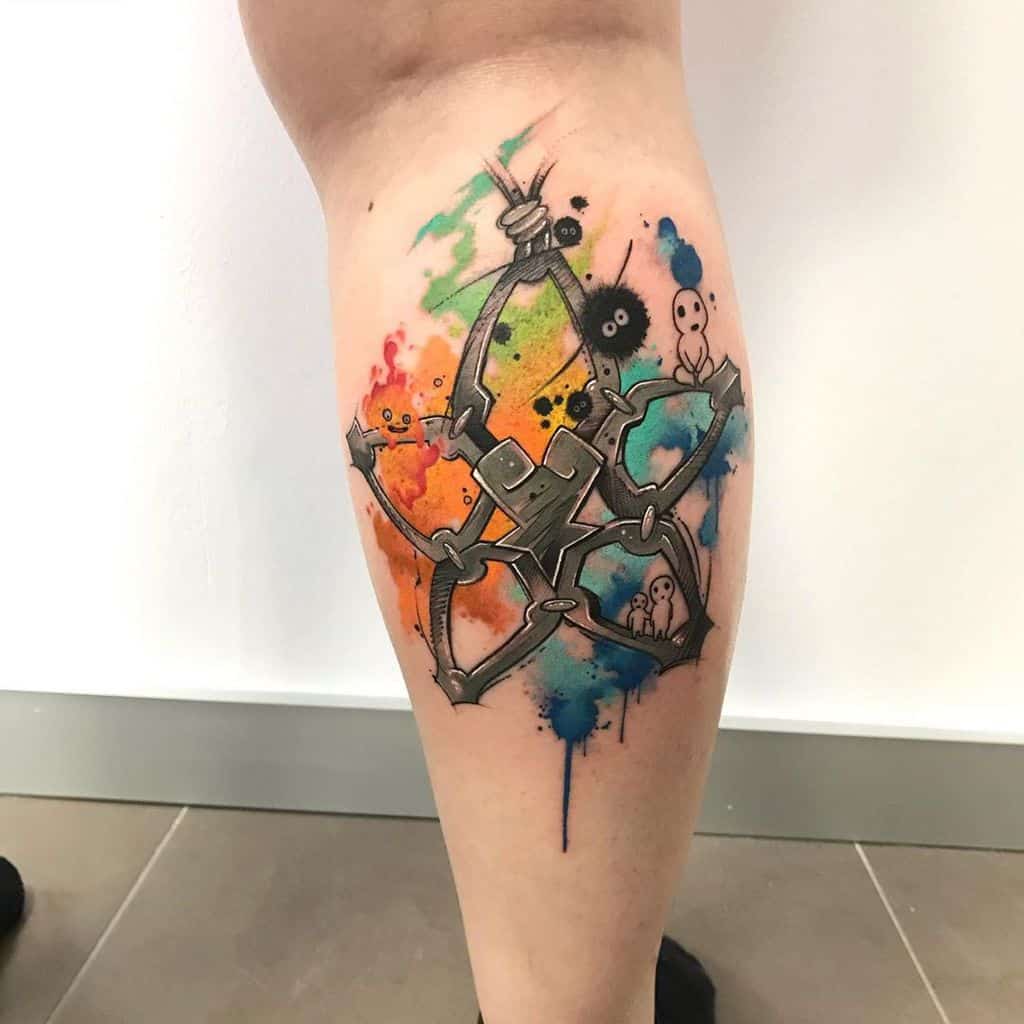 Kingdom Hearts-inspired tattoo of Roxas's Keyblade, the Oblivion shuriken, with watercolor splashes and Studio Ghibli soot sprites on the calf.