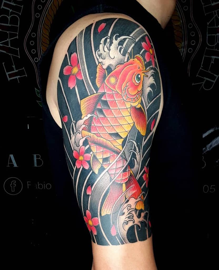 Colorful koi fish and pink flowers tattoo on upper arm