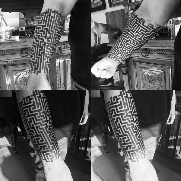 Bold blackwork labyrinth tattoo on a man's forearm, featuring a complex maze pattern wrapping around the arm in a geometric sleeve design.