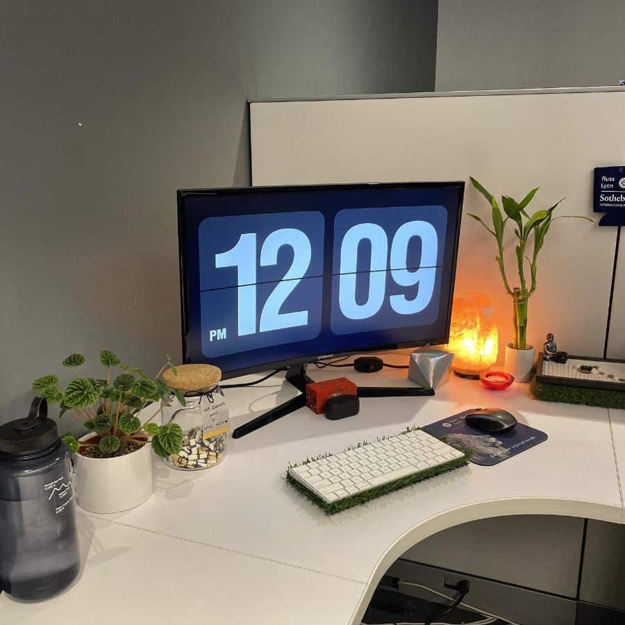 office setup computer screen candle plants