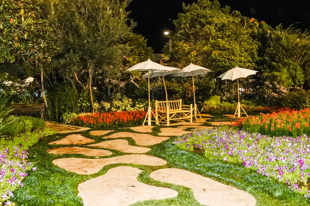 landscaped flower garden stone pavers umbrellas
