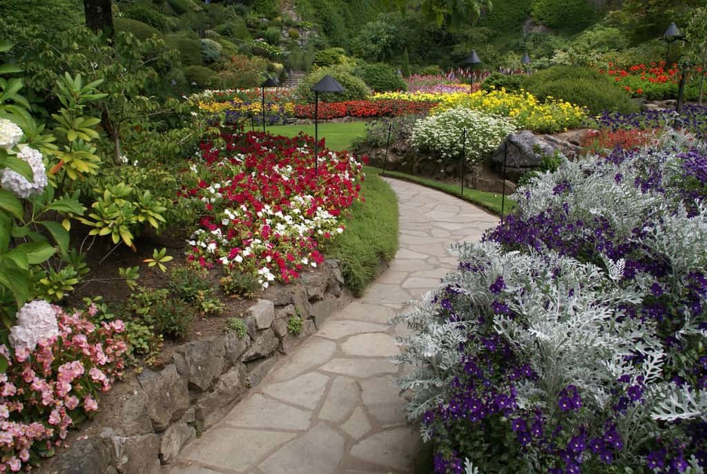 large landscaped flower garden stone pathway