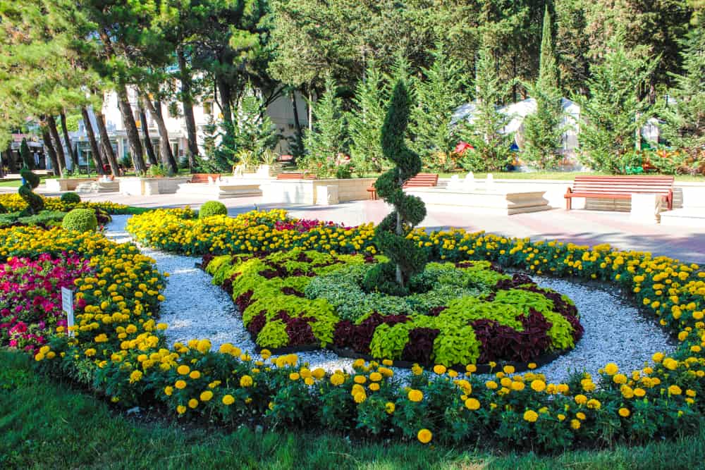 landscaped flower garden in park park benches