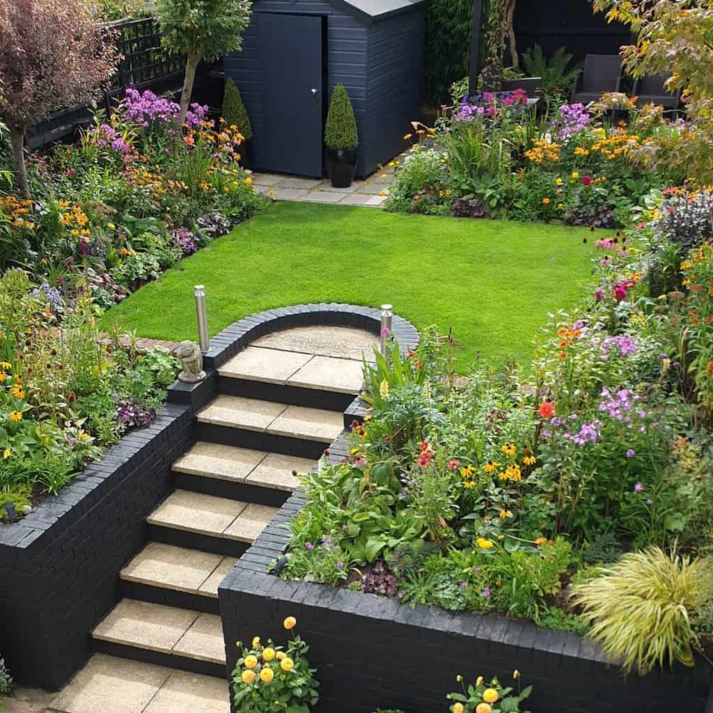 landscaped backyard flower garden gray shed lawn
