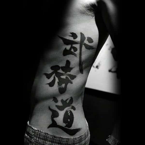 Large Chinese Words Mens Black Ink Tattoo Design On Ribs