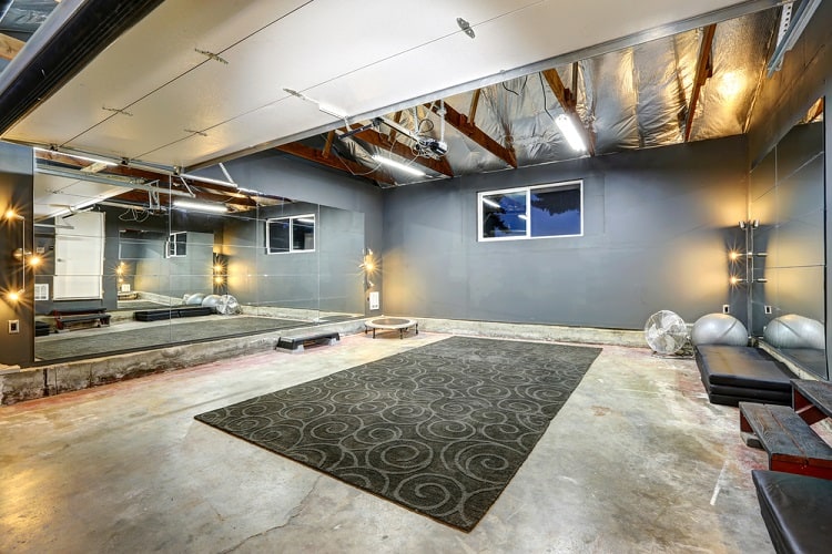 large basement gym wall mirror concrete floor 