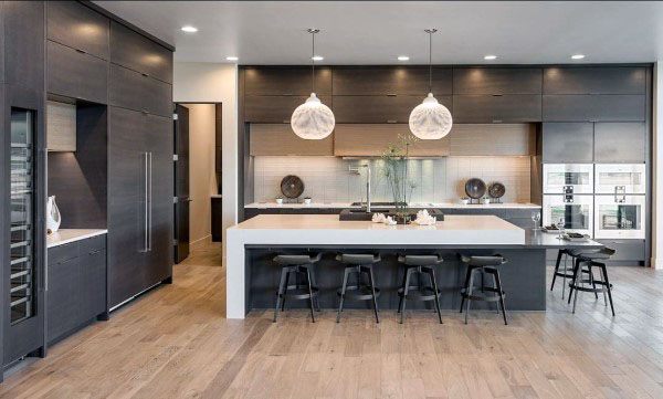 large contemporary kitchen with brown cabinets and white marble countertop 