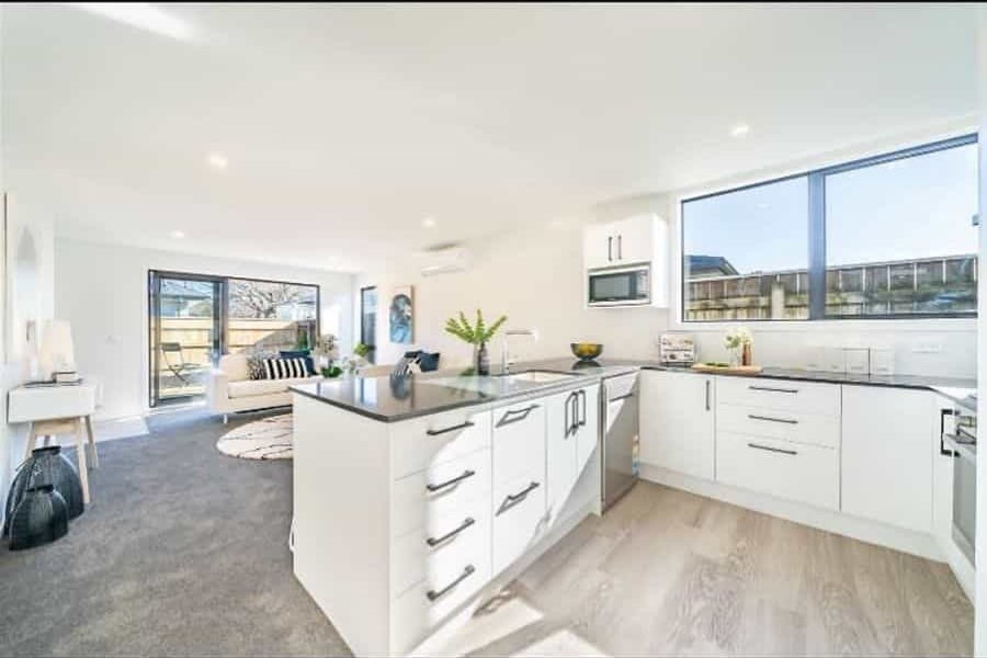 large open kitchen living room white cabinets and sofa