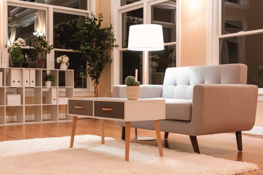 large luxury mid-century modern living room with gray sofa and white coffee table