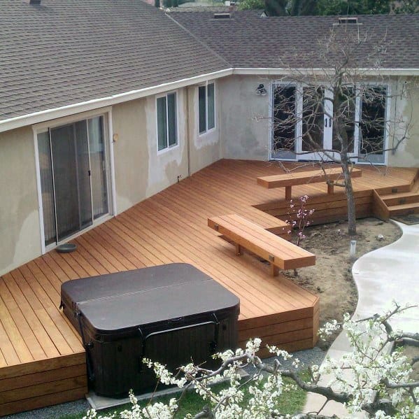 wood deck with bench seats and hot tub