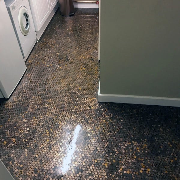 Glossy penny floor in a laundry room, offering a unique and reflective surface.