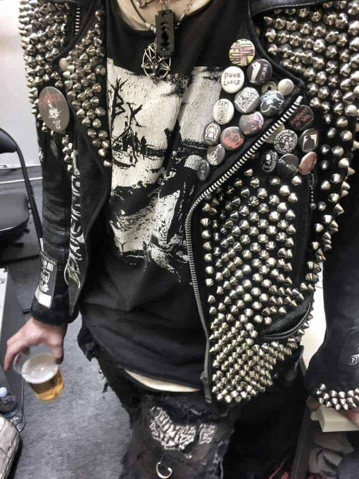 Man wearing a leather jacket with pins and spikes